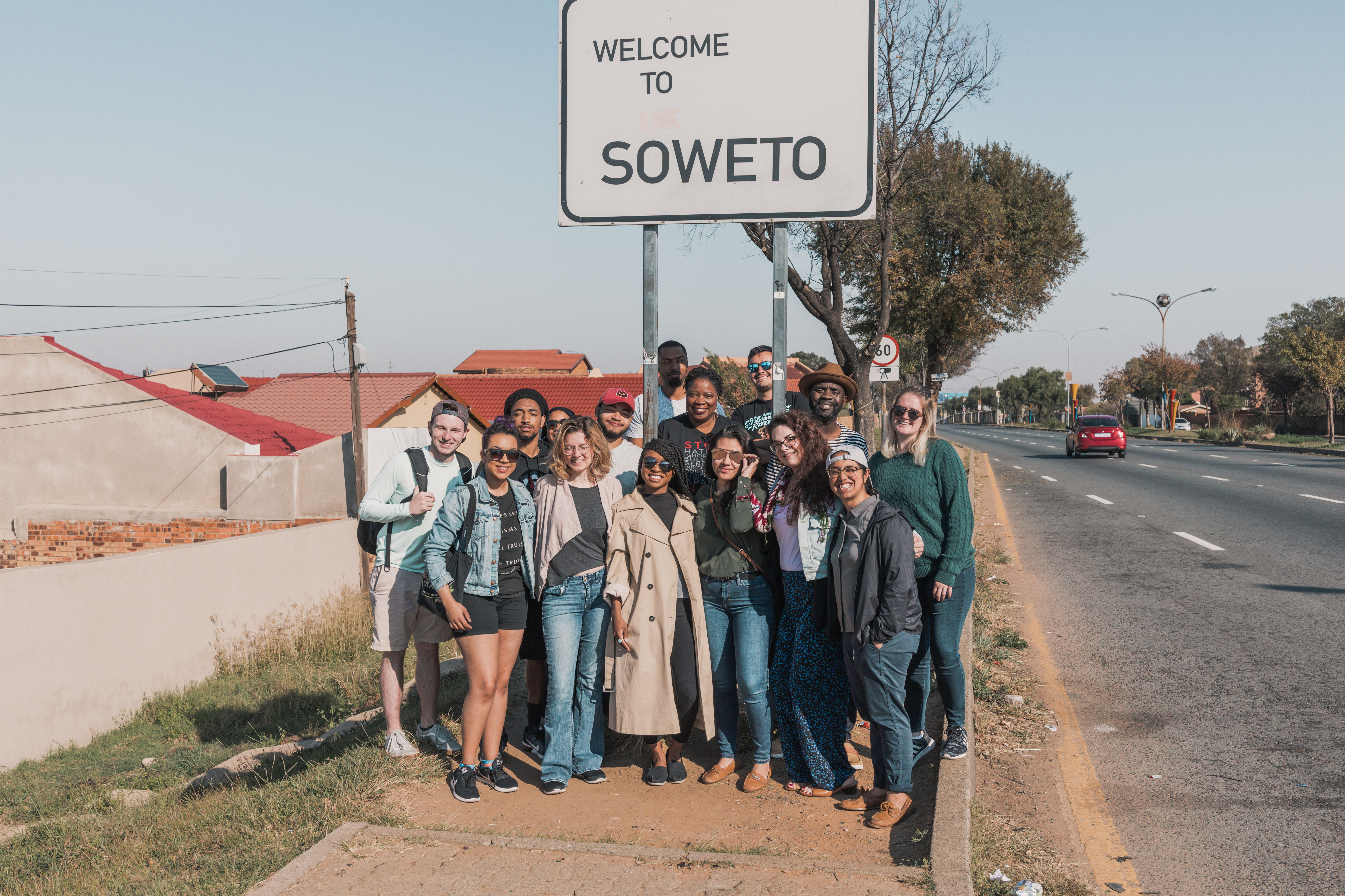 TU Students by Soweto sign